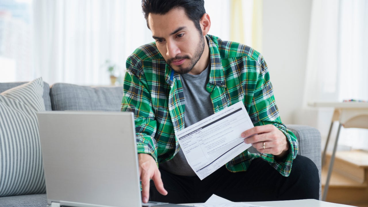 A man looks over bills.