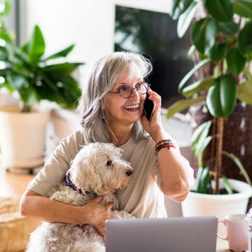 Woman on cell phone with dog