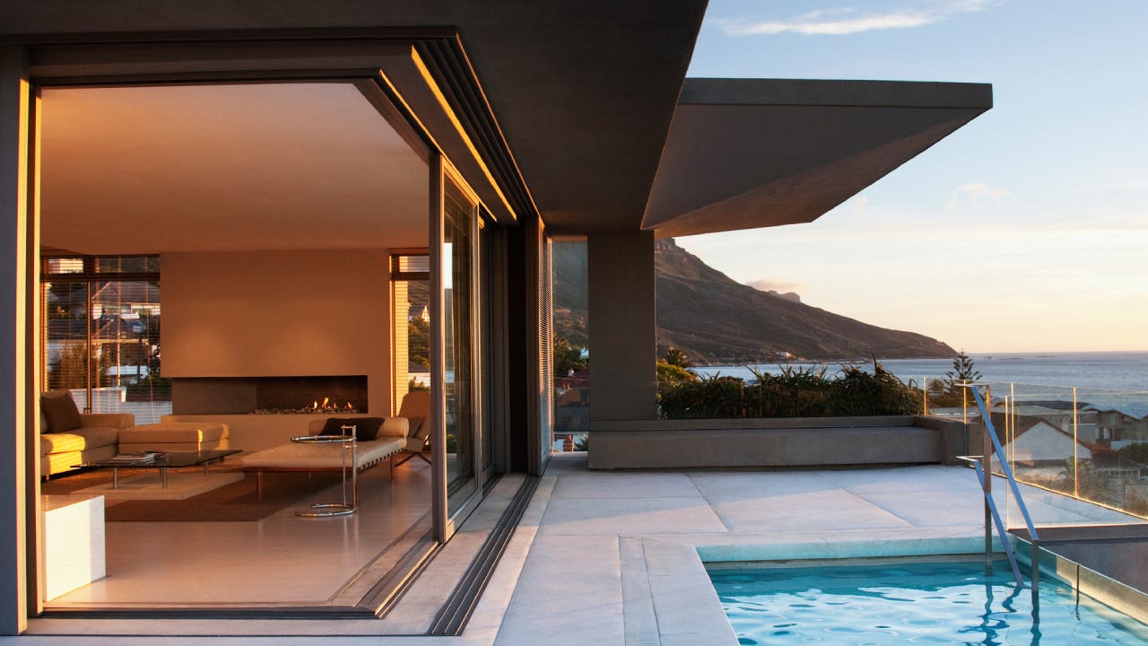 Modern living room and patio next to swimming pool