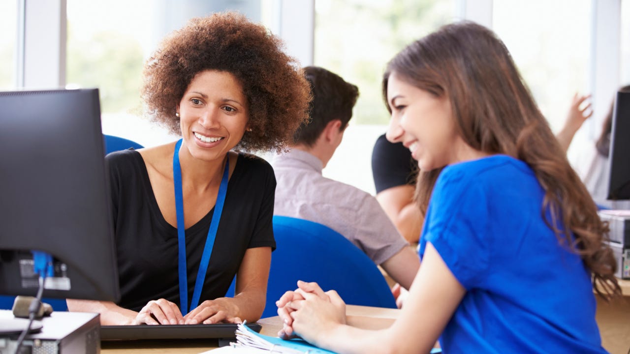 Financial Advisor Providing Advice Smiling Looking At Laptop