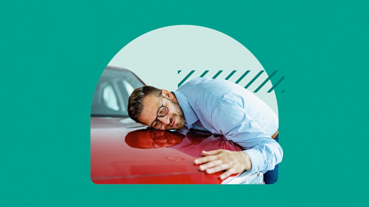 Middle aged white man leans against a red car while smiling. Image is on a green background.