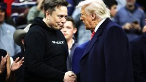 Elon Musk and Donald Trump shaking hands.